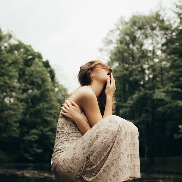 Calm person sitting in a relaxed pose in a bright, peaceful environment.